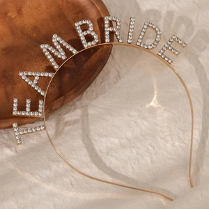 Close-up of golden rhinestone headband with TEAM BRIDE lettering for weddings