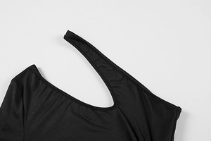 Detail of a black one-shoulder dress showing clean-cut edges and premium knit texture