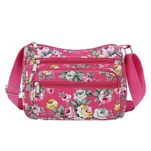 Floral print crossbody bag for women with pink rose patterns and multiple zipper pockets
