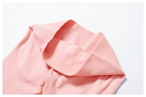 Close-up of the ribbed high-waist band on pink seamless yoga leggings for tummy control