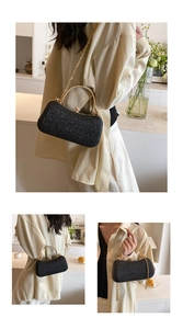 Detail of black glitter evening clutch featuring gold metal handle and chain strap