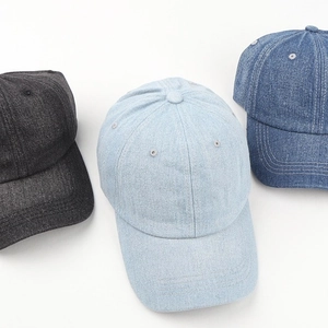 Washed denim baseball caps in dark grey, light blue, and navy blue with reinforced stitching
