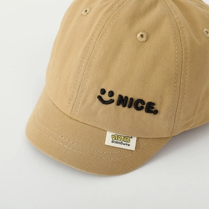 Detail of khaki cotton baby baseball cap featuring smile and NICE letter embroidery