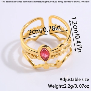 Macro detail of adjustable gold ring featuring red marquise stone and hollow wave bands