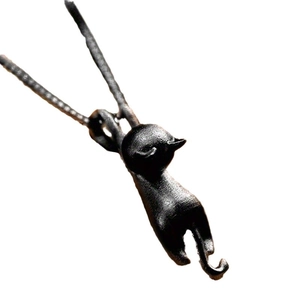 Minimalist black cat pendant necklace featuring a climbing feline design on a fine chain