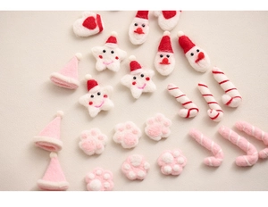 Close-up of handmade Christmas wool felt ornaments including Santa and star shapes