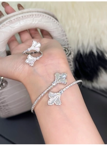 Detailed view of luxury 18k gold fan-shaped bracelet and ring set with mother of pearl