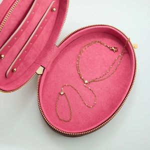 Pink velvet jewelry box with luxury gold zircon chain bracelet inside on grey backdrop