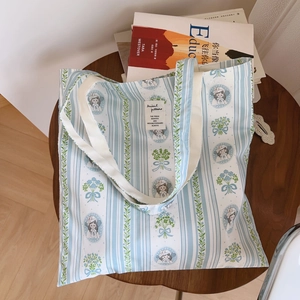 Détail du sac fourre-tout en coton avec imprimé floral, portrait vintage et rayures
