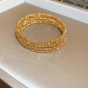 Detailed view of the five-layer gold-plated beaded bracelet with fine metallic texture