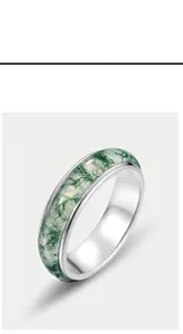 Detailed 45-degree angle of S925 silver ring with natural green moss agate stone