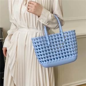 Light blue hollow woven jelly bag tote for summer beach holidays shown with a model