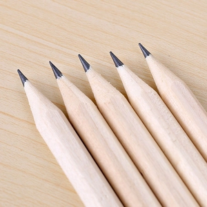 Five sharpened hexagonal wooden HB pencils arranged neatly on a light wood background