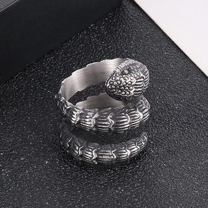 Top view of retro silver snake ring with realistic scale texture and coiled punk design