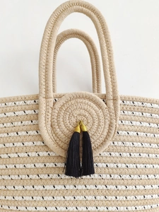 Large capacity striped woven straw tote bag with black tassel and gold hardware accents
