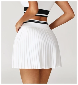 Detail view of white pleated sports skirt with black and white striped elastic waistband