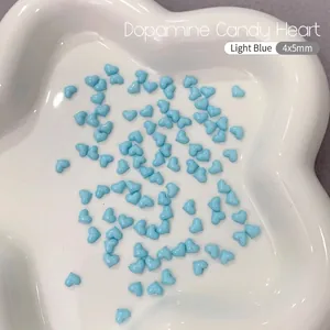 Detailed macro view of 4x5mm light blue resin heart charms for nail art and DIY decor