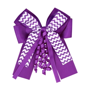 Detail showing high-quality purple and white ribbed ribbon bow with elegant spiral tassels