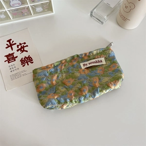 Detail of floral makeup bag with lace fabric texture and secure zipper closure