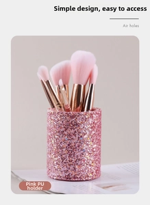 Detailed view of pink PU makeup brush holder with glitter finish and ventilation holes