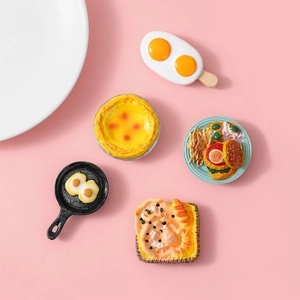 DIY food resin fridge magnets featuring egg tarts and burgers on a pink background