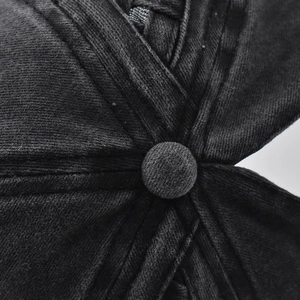 Close-up of the top button and stitching on this washed cotton criss-cross ponytail cap