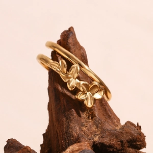 Detailed macro view of 18K gold plated double layer ring with two small flower designs
