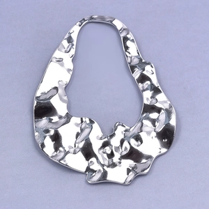 Macro shot of silver hammer textured 304 stainless steel irregular pendant accessory