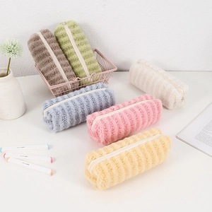 Detail of colorful striped plush pencil cases in a metal storage basket for stationery