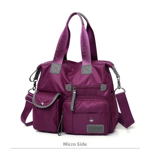 Detailed close-up of a purple nylon travel bag showing side pockets and fabric texture