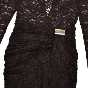 Macro detail of black lace bodysuit featuring a deep V-neck and gold buckle at the waist
