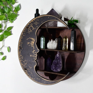 Detail of bohemian moon phase wooden shelf with crystal display and celestial carvings