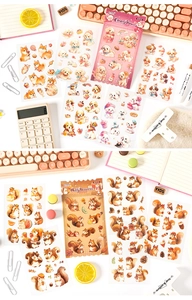 Macro shot of cute watercolor dog and squirrel stickers on an organized desk setup