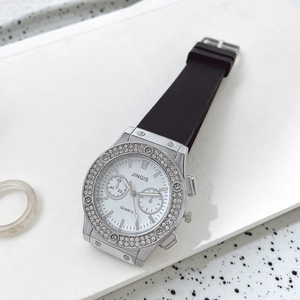 Detail of silver quartz watch with dual-dial white face and double rows of sparkling crystals
