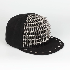 Detail of black punk baseball cap featuring silver metal spikes and round studs on brim