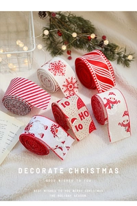 Close-up of Christmas ribbon set with snowflakes and Santa patterns on faux fur background