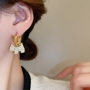 Macro shot of gold-plated Scottish Terrier stud earring with pavé zircon crystals