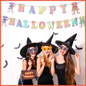 Close-up of rainbow Happy Halloween letter banners and spooky party props with models