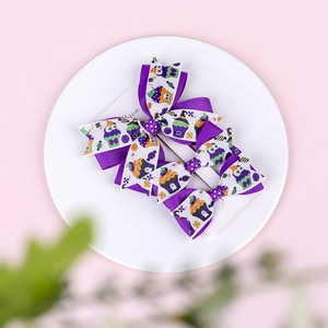 Three-piece Halloween hair bow set with ghost and pumpkin patterns on ribbed ribbons