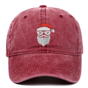 Close-up of Santa Claus embroidery on vintage washed red cotton baseball cap