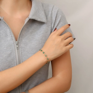 18K gold plated stainless steel bracelet featuring green evil eye charms for women