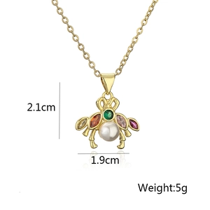 Macro view of bee pendant necklace with pearl and colorful crystals showing 2.1cm dimensions