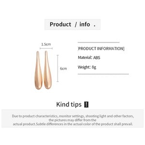 Close-up detail of minimalist polished water drop earrings with irregular smooth finish
