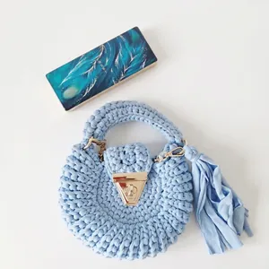 Light blue handmade crochet bag with golden clasp and large tassel for women