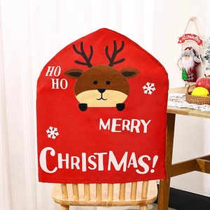 Detail view of red Christmas chair cover featuring cartoon elk and Merry Christmas text