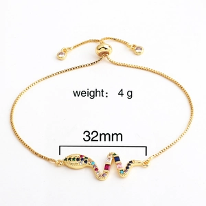 Detail of adjustable brass gold-plated snake charm bracelet with colorful cubic zirconia