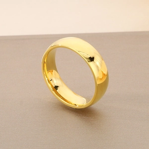 Detailed view of a 6mm polished gold stainless steel ring with smooth reflective surface