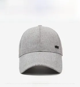 Front view of grey summer mesh baseball cap with long visor and metal logo side detail