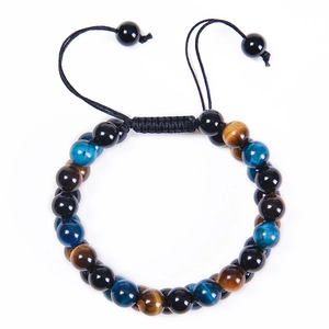Macro view of blue and brown tiger eye beads with adjustable black nylon cord