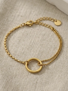 Detail view of gold 18k minimalist bracelet with bead chain and round pendant charm